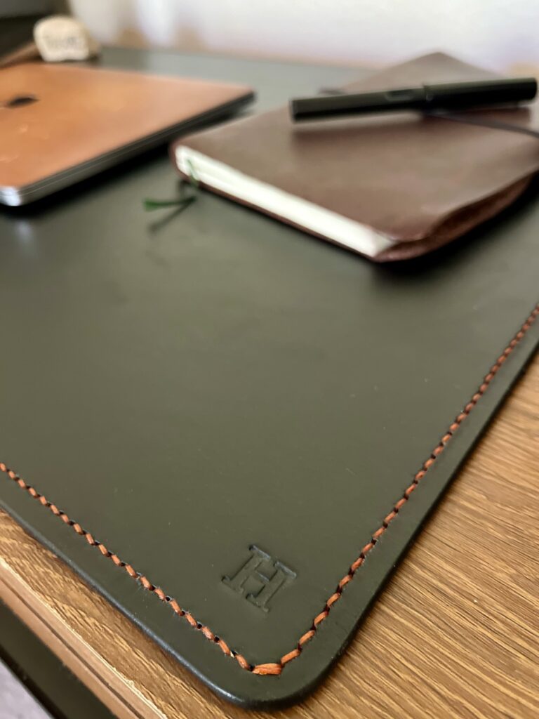 Green stitched leather desk mat with handmade leather notebooks