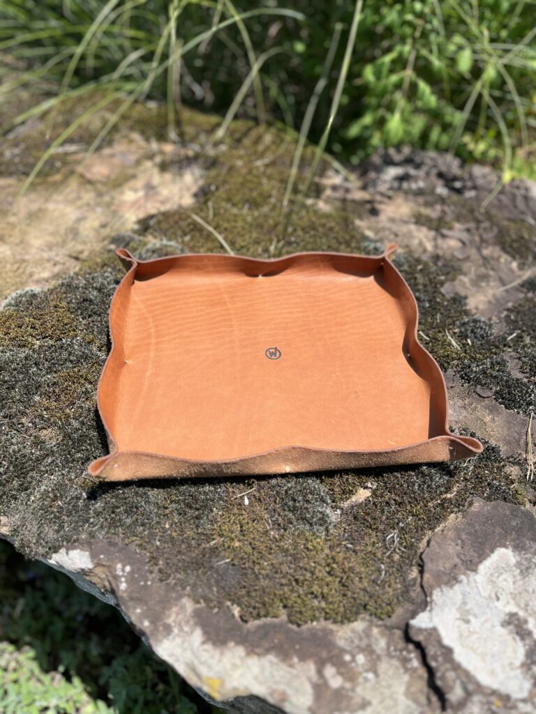 Handmade leather catchall tray photographed outdoors
